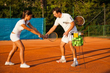 tennis instructor teaching